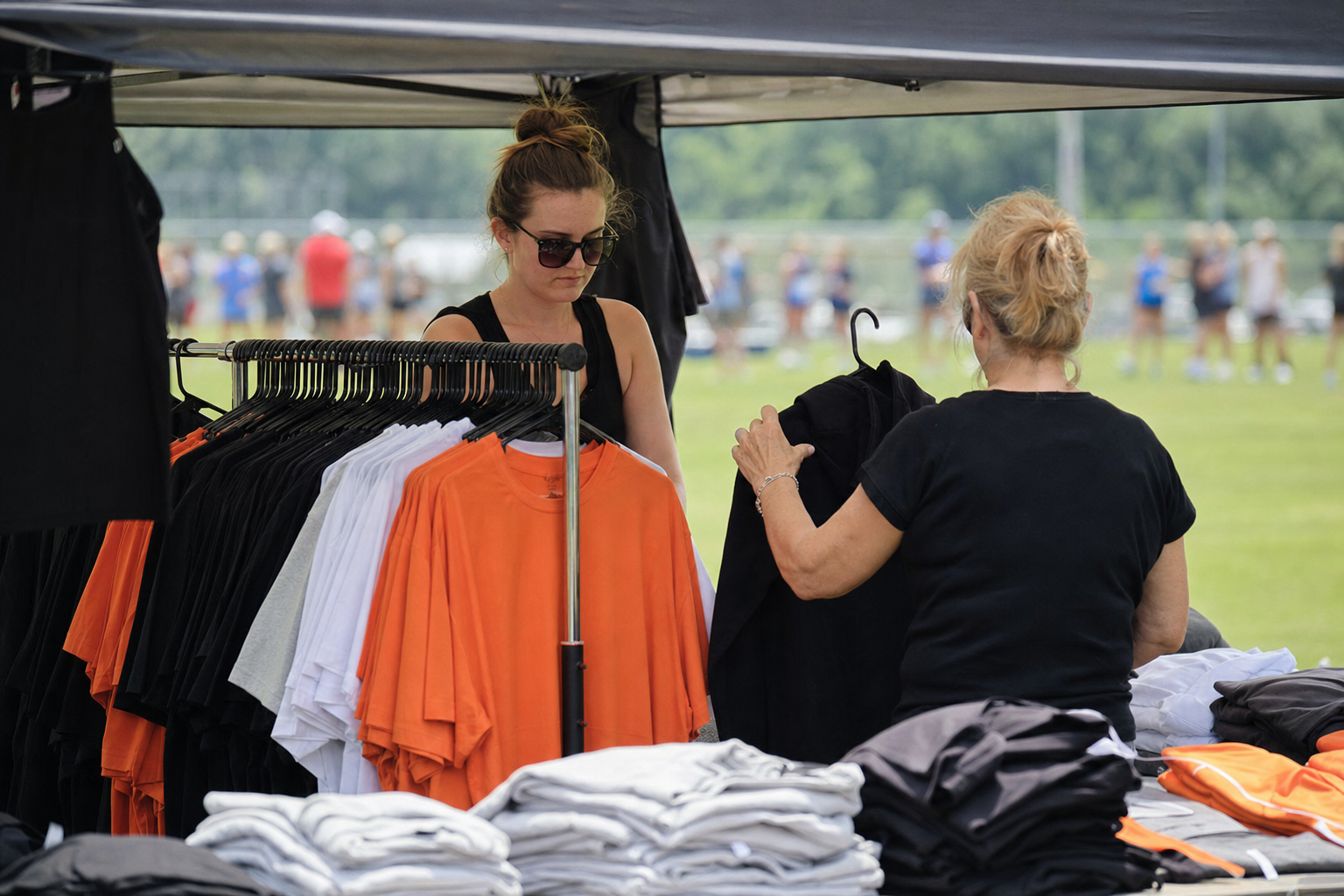 Families shopping the SPG apparel booth at a tournament